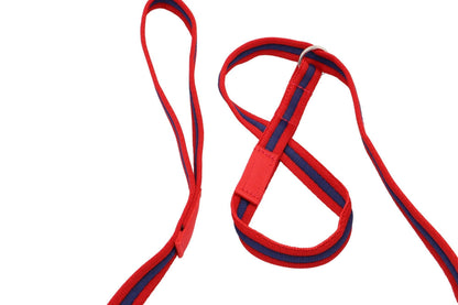 A close up view of the '8' and the handle of a figure of 8 dog lead. The lead is in an alternate red, blue, red of triple ridged Softex webbing.