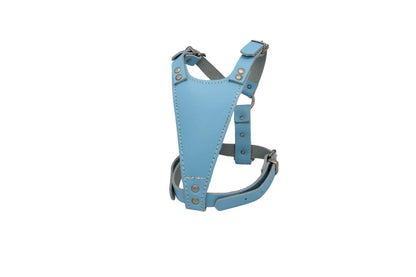 A light blue leather puppy harness slightly offset so that you can see the breast piece and the inside of the back of the harness