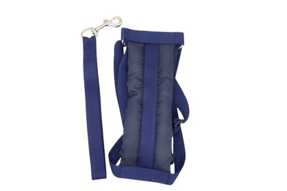 Neatly placed navy dog harness with a short handled lead to the side