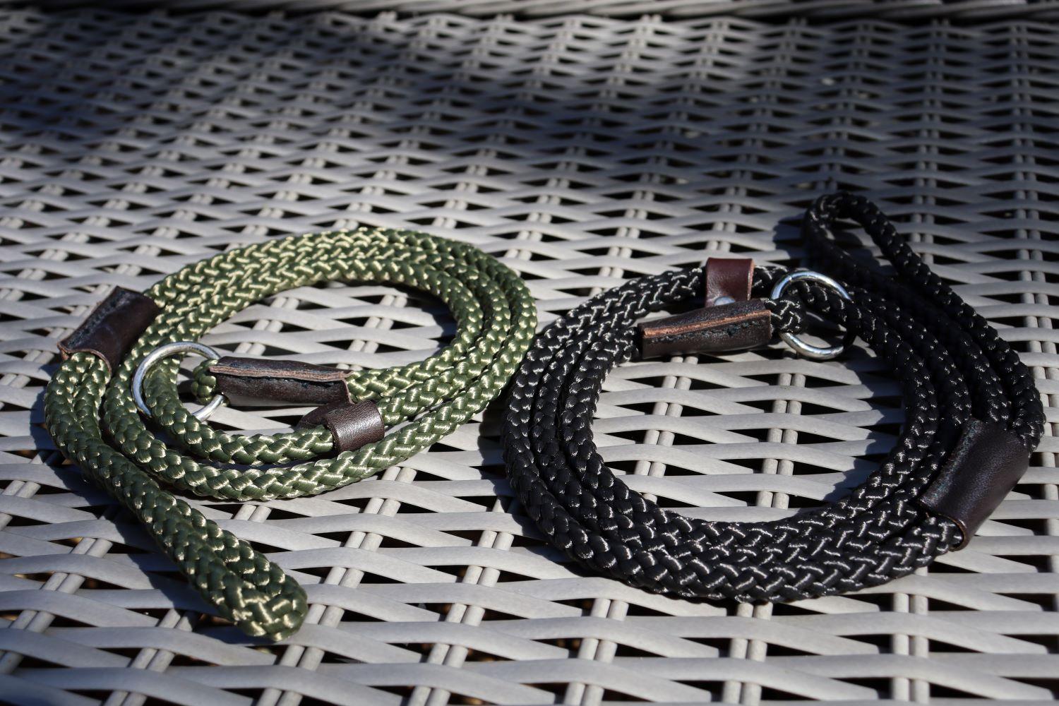 A black and an olive green slip lead  on rattan furniture with a low sun lighting and shadows of tree branches in the background giving the photo a low light effect and reflecting the leads.