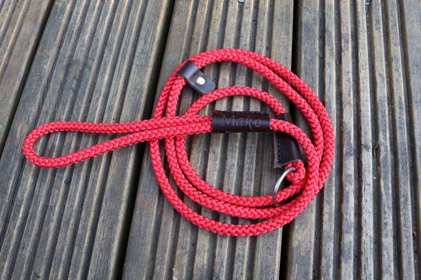 Red slip leash with a nickel ring and leather bindings.